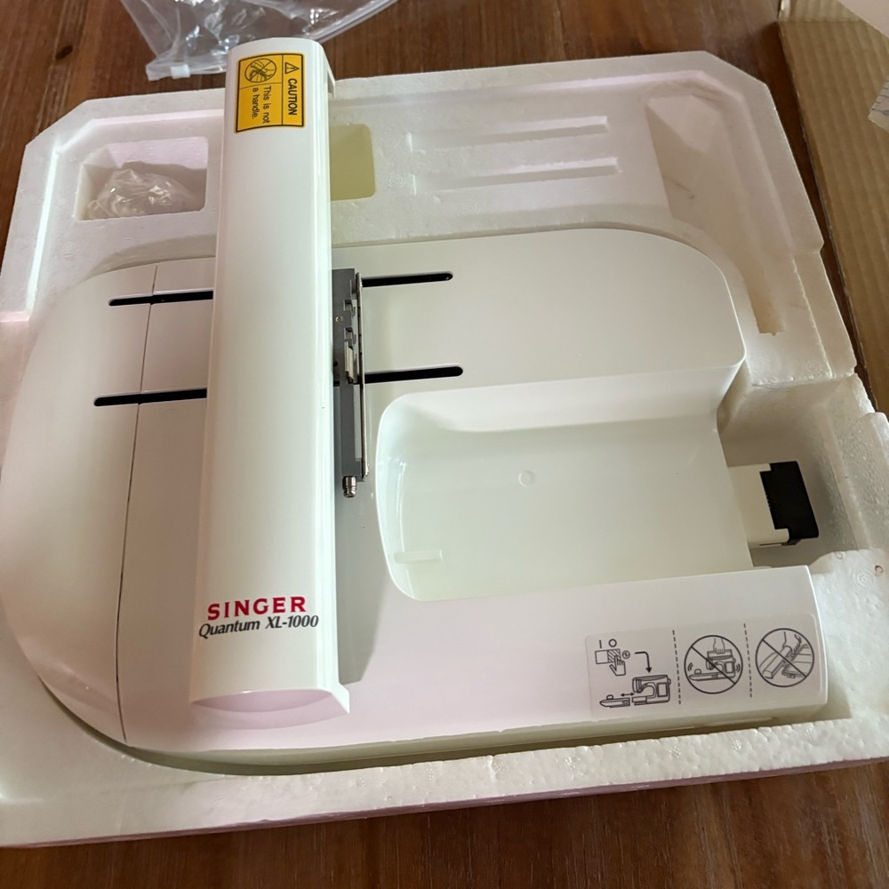 Singer Quantum XL-1000 embroidery attachment with hoops and stencils.
